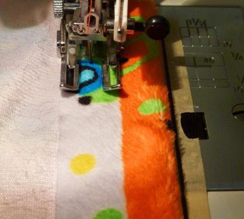 An image of sewing the folded edge of a pillowcase