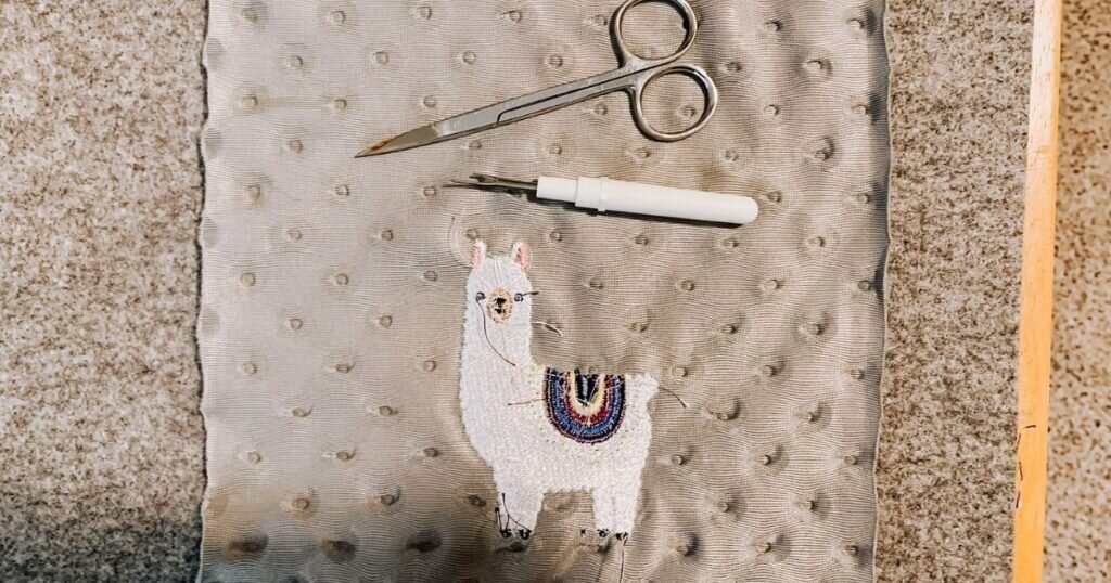 An image of trimming threads from embroidered minky fabric