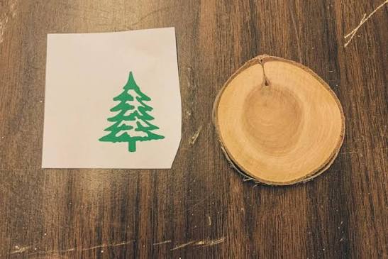 Tree design template beside a wood slice