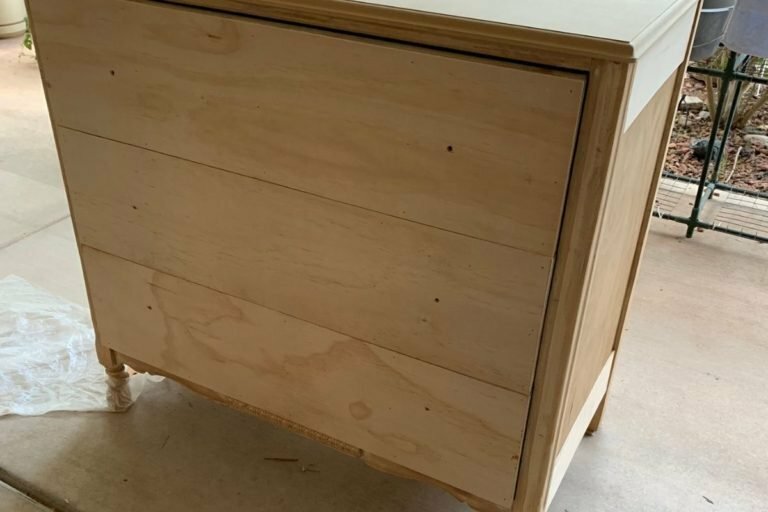 An image of a vintage dresser being sanded