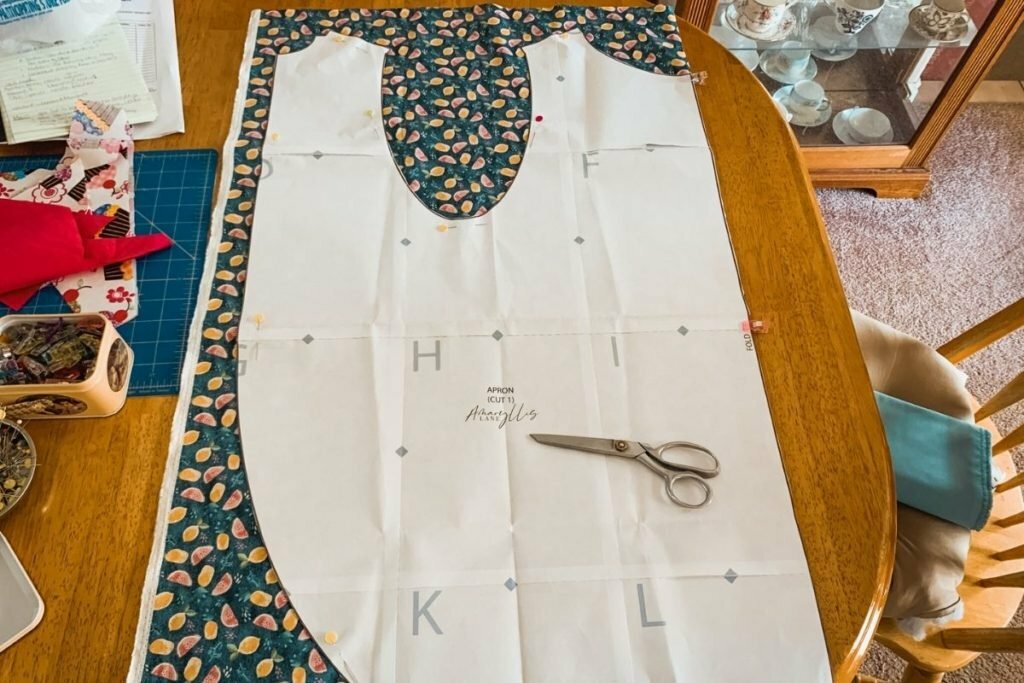 An image of fabric being cut for the apron pattern