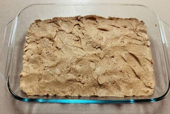 An image of peanut butter mixture pressed into a pan